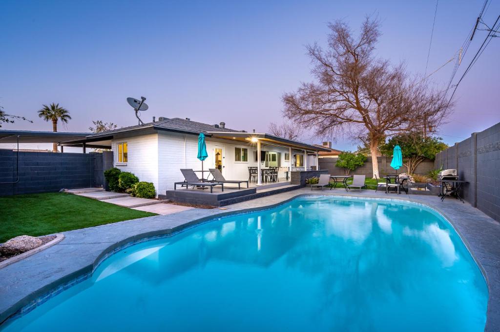 a swimming pool in the backyard of a house at Cambridge by Porter Modern Home wHeated Pool Near El Dorado Park in Scottsdale in Scottsdale