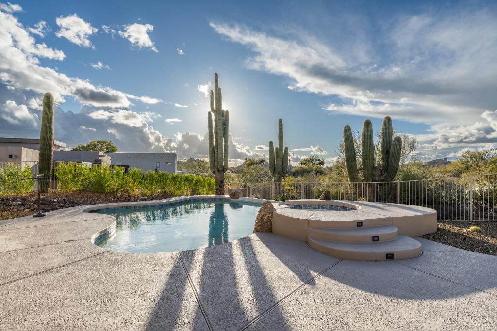 a swimming pool in a yard with cactus at Pinnacle Perfection by Porter Heated Pool Spa w Outdoor Putting Green in Scottsdale