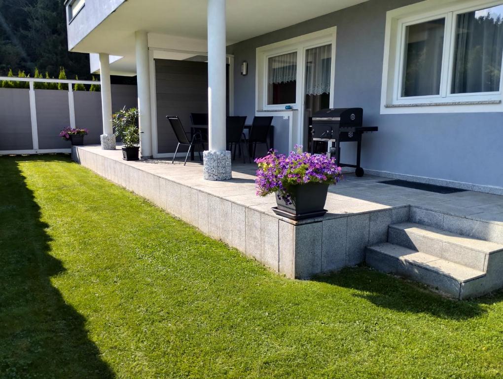 a house with a patio with flowers on it at Appartement Julian in Fügen