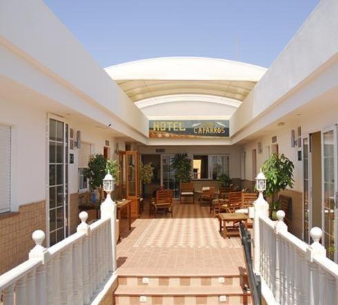 a hallway of a building with chairs and tables at Hotel Donde Caparrós in Carboneras