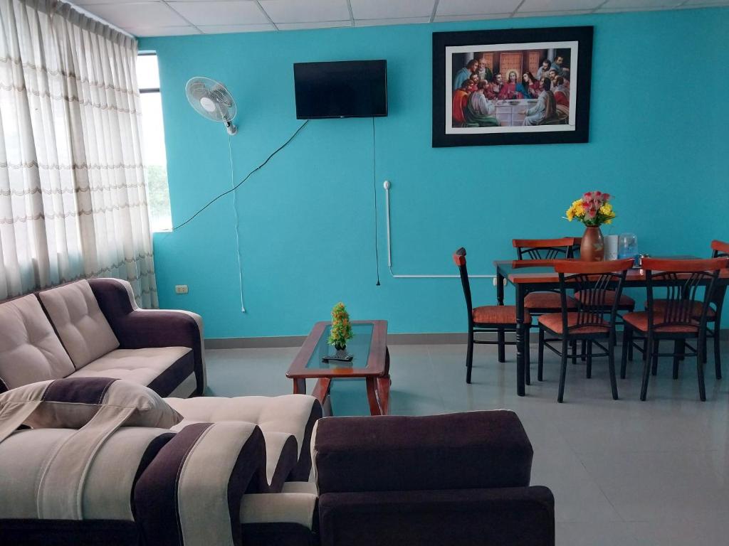 a living room with a couch and a table at Departamento de 4 camas dobles in Moyobamba