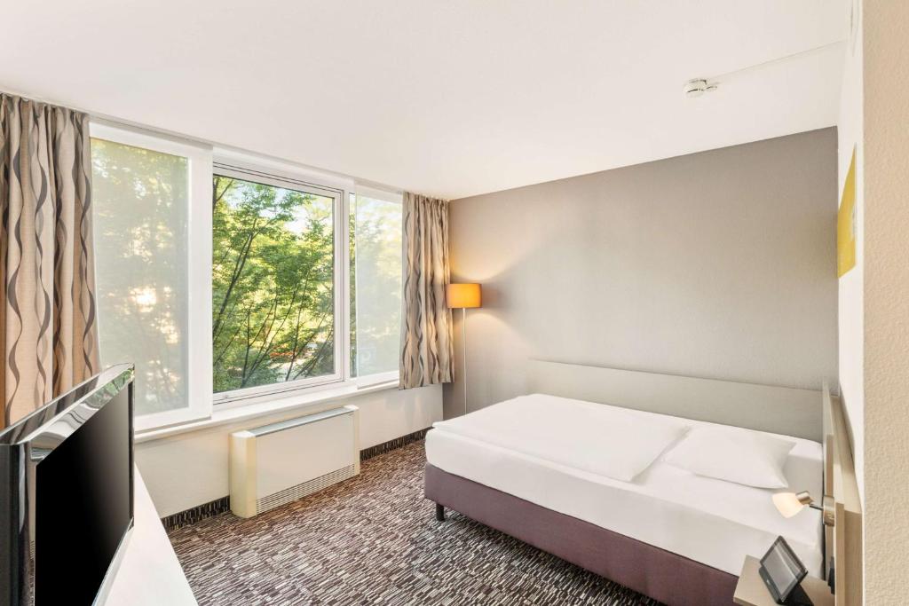 Postel nebo postele na pokoji v ubytování Best Western Plus Hotel Dresden City