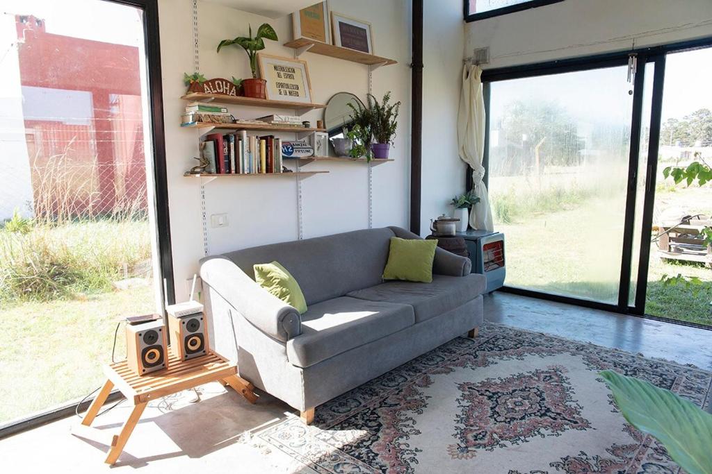 a living room with a couch and a table at Casa de Playa Los Lobos Chapa in La Estafeta