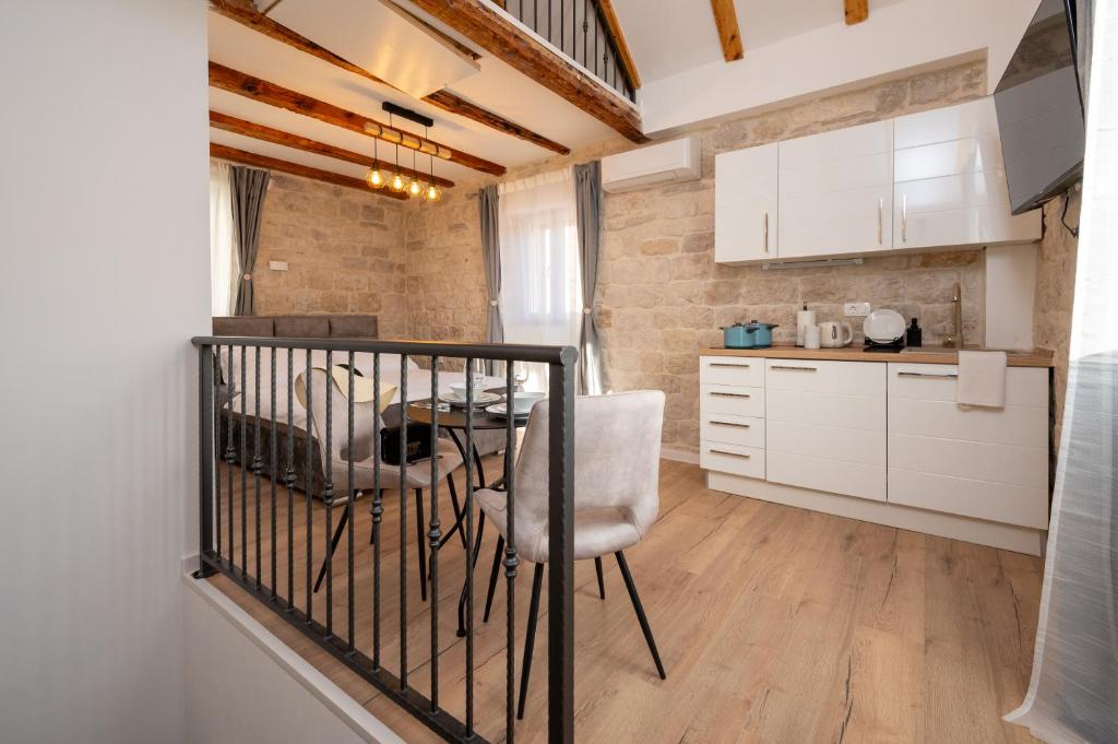 a kitchen with a table and a chair in a room at Apartment Villa IV in Trogir
