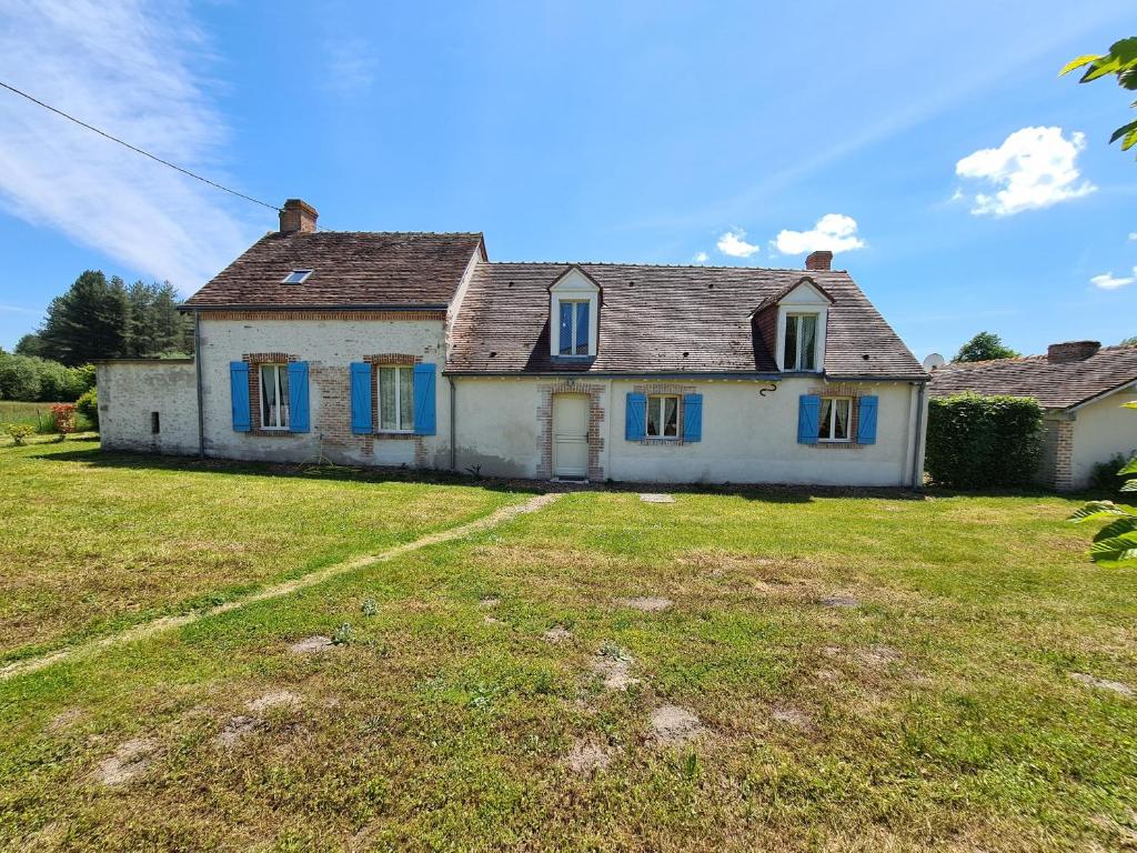 an old house with blue windows and a yard at Maison solognote calme et boisée, proche châteaux Loire, golf, vélos, ping-pong - FR-1-590-34 in Jouy-le-Potier