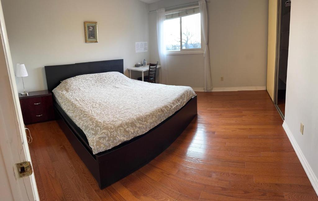 a bedroom with a bed and a wooden floor at 201 Large Private Bedroom on second floor in Mississauga