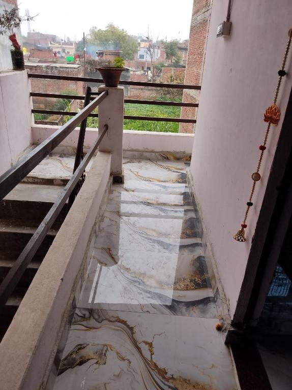 a view from the balcony of a house with water on the floor at Arshu apartment in Prayagraj