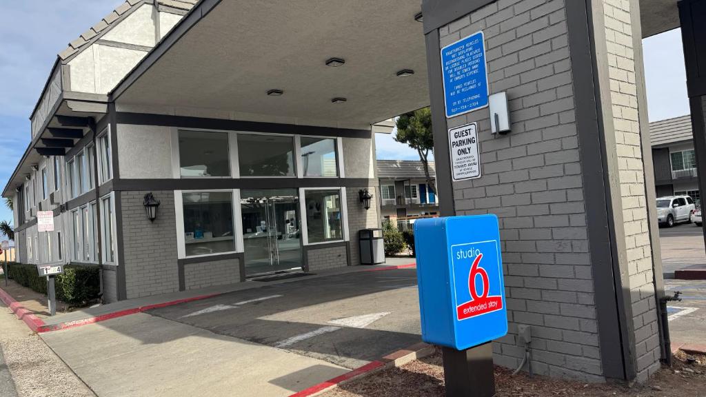 a building with a blue sign in front of it at Studio 6 Corona, CA West in Corona