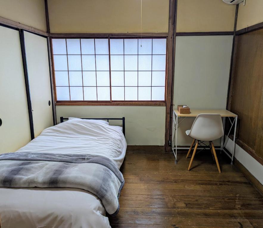 Postel nebo postele na pokoji v ubytování Kanazawa TABI-NE