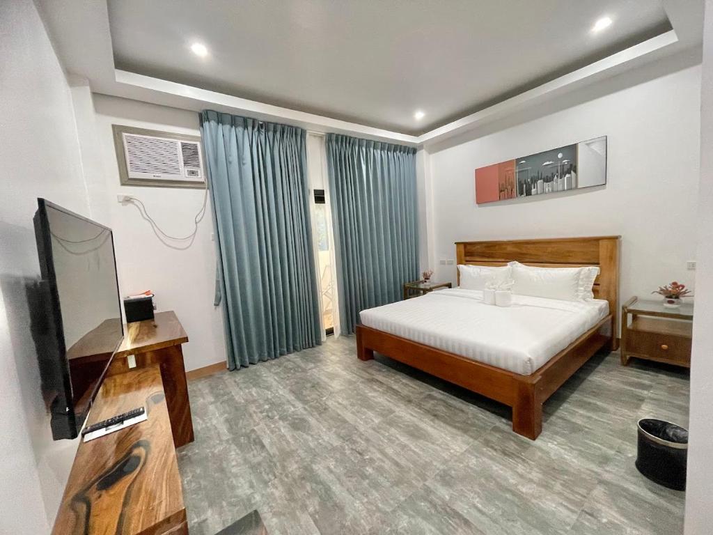 Postel nebo postele na pokoji v ubytování Ocean Star Hotel Coron