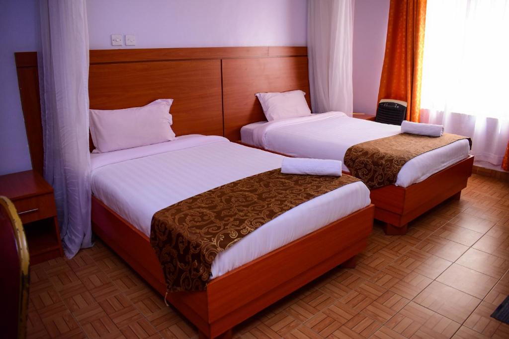 Postel nebo postele na pokoji v ubytování Sunstar Hotel Nairobi