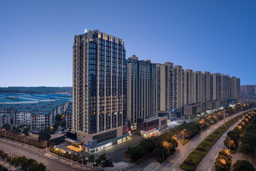 a large tall building in a city with a street at Days Hotel by Wyndham Changsha Yuhua West in Changsha