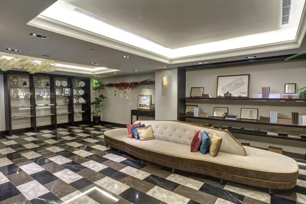 a large couch in a room with a checkered floor at 53 Hotel in Taichung