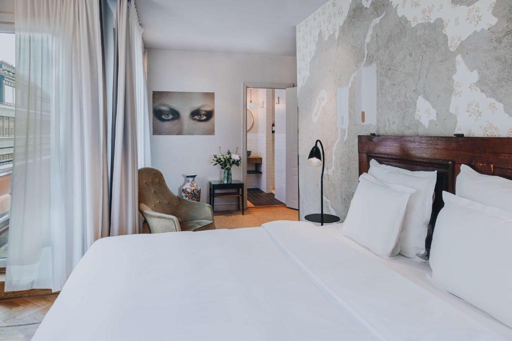 a bedroom with a large white bed and a window at Story Hotel Riddargatan, part of JdV by Hyatt in Stockholm