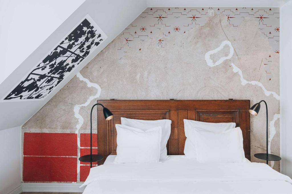 a bedroom with two beds and a wall with stars at Story Hotel Riddargatan, part of JdV by Hyatt in Stockholm