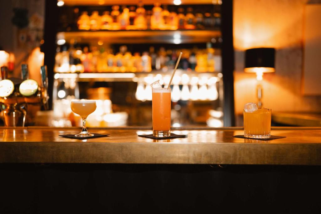 two drinks sitting on top of a bar at Story Hotel Riddargatan, part of JdV by Hyatt in Stockholm