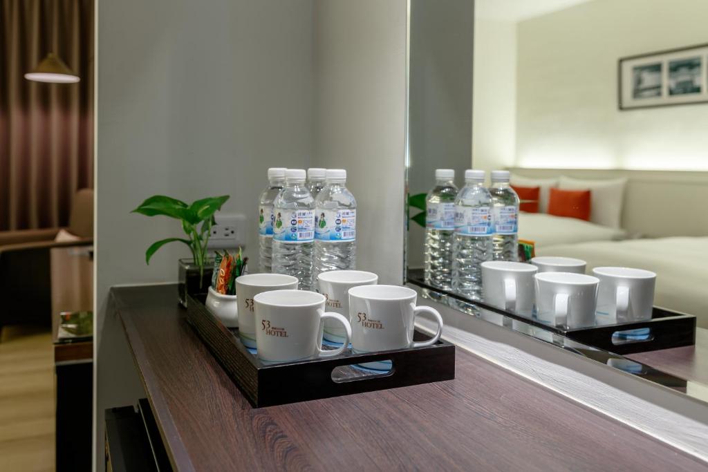 a tray with cups and water bottles on a table at 53 Hotel in Taichung