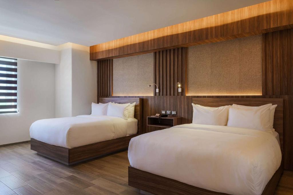 Postel nebo postele na pokoji v ubytování Radisson Puebla Angelopolis