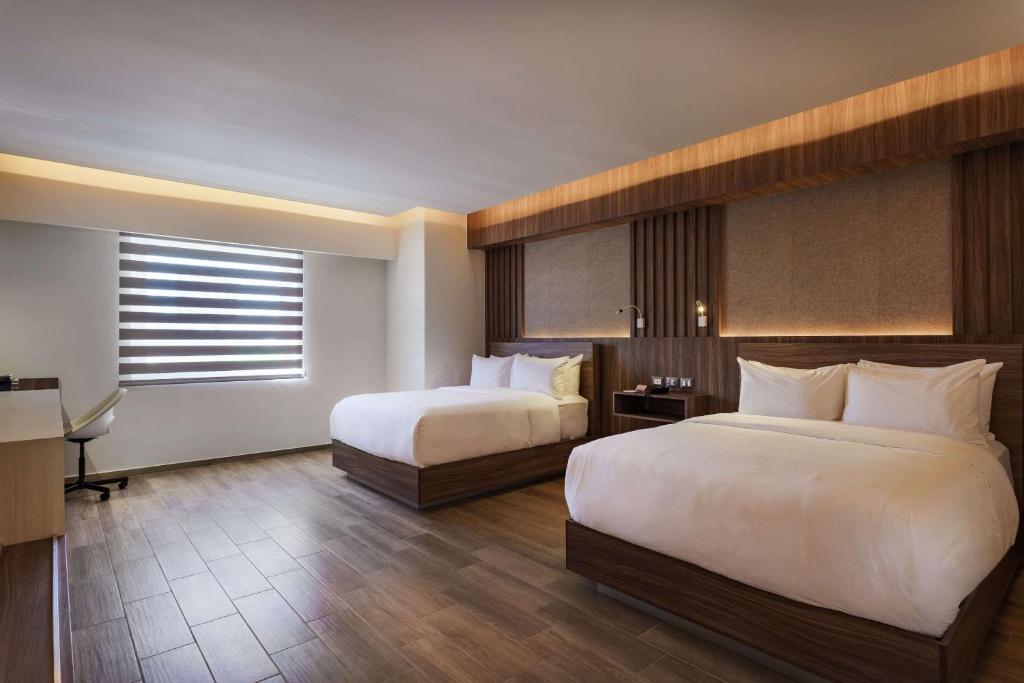 Postel nebo postele na pokoji v ubytování Radisson Puebla Angelopolis