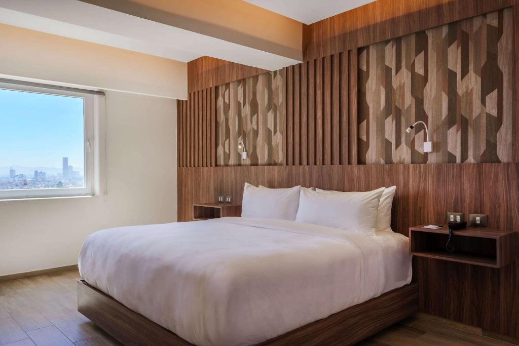 Postel nebo postele na pokoji v ubytování Radisson Puebla Angelopolis