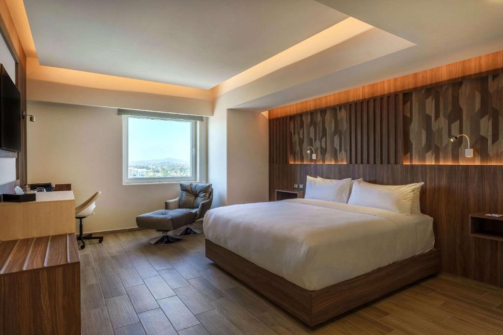 Postel nebo postele na pokoji v ubytování Radisson Puebla Angelopolis