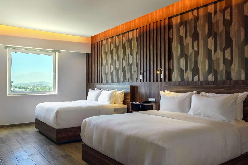 Postel nebo postele na pokoji v ubytování Radisson Puebla Angelopolis