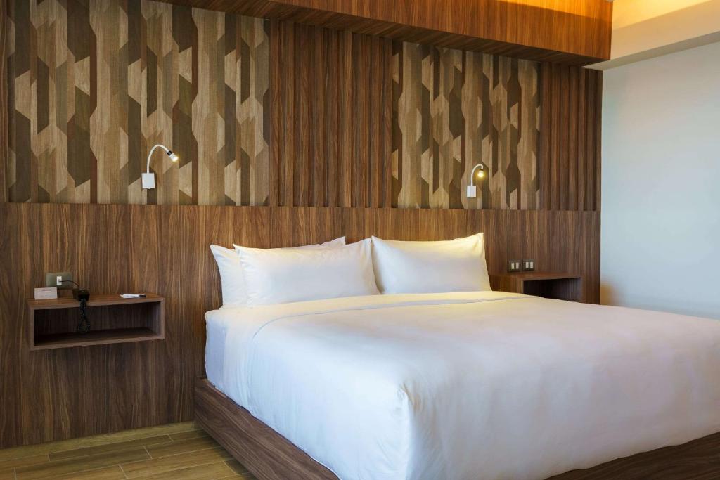 Postel nebo postele na pokoji v ubytování Radisson Puebla Angelopolis