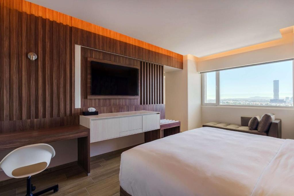 Postel nebo postele na pokoji v ubytování Radisson Puebla Angelopolis