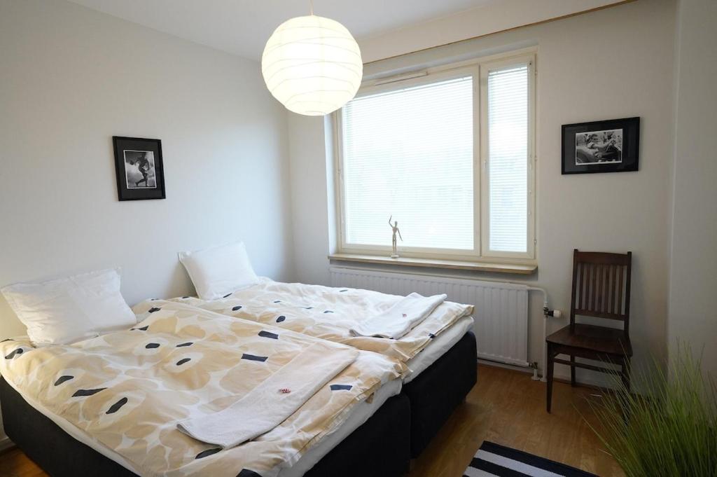 a bedroom with a large bed and a window at A two-bedroom with river view in Kajaani