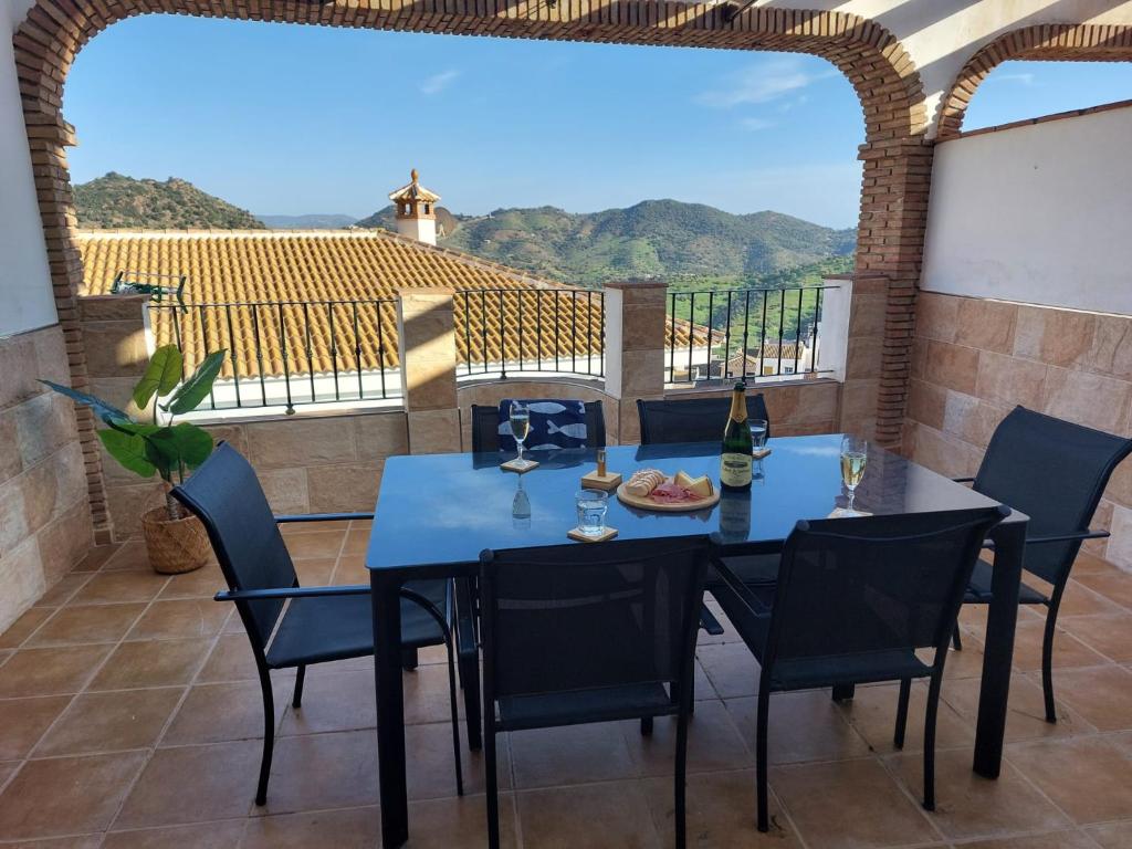 a table and chairs on a patio with a view at Mi casa en Almogia - Andalucia in Almogía