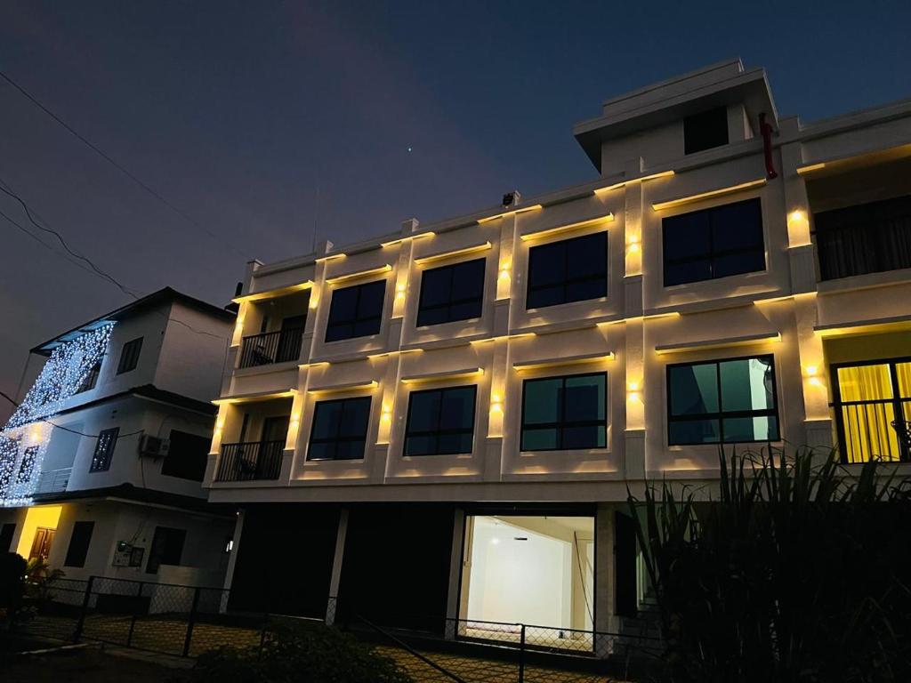 a lit up building with lights on it at night at Brighton Stays in Sultan Bathery