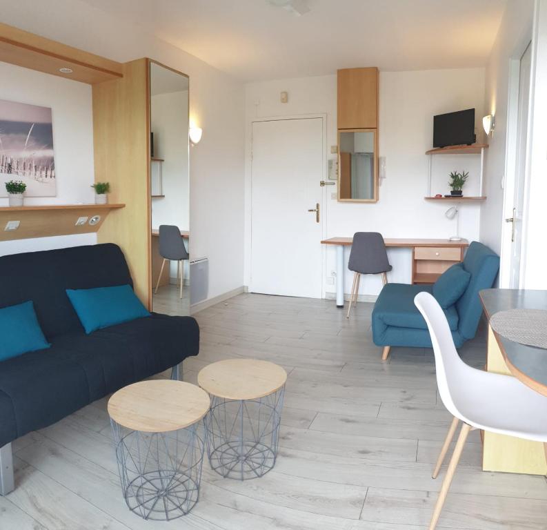 un salon avec un canapé et une table dans l'établissement Appartement La Rochelle, à La Rochelle