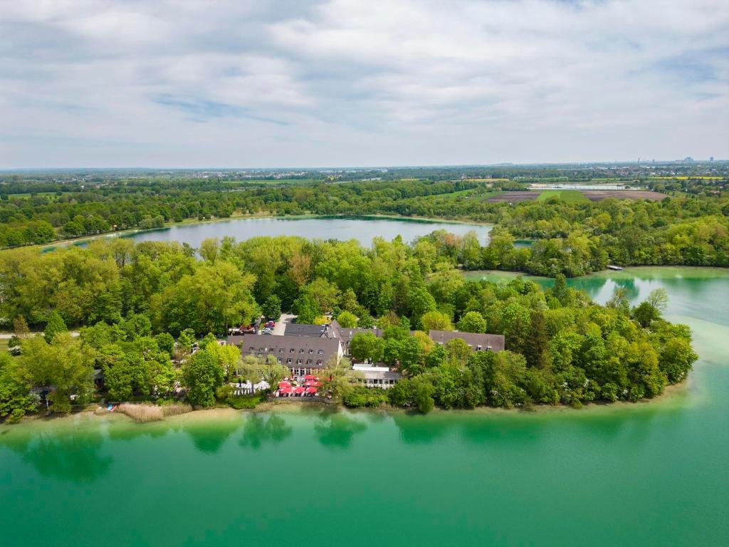 an aerial view of a house on an island in a lake at Langwieder See in Munich