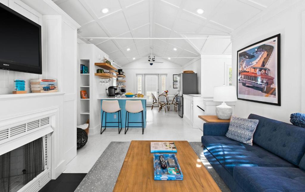 a living room with a blue couch and a table at Just for Fun 2 in Santa Rosa Beach