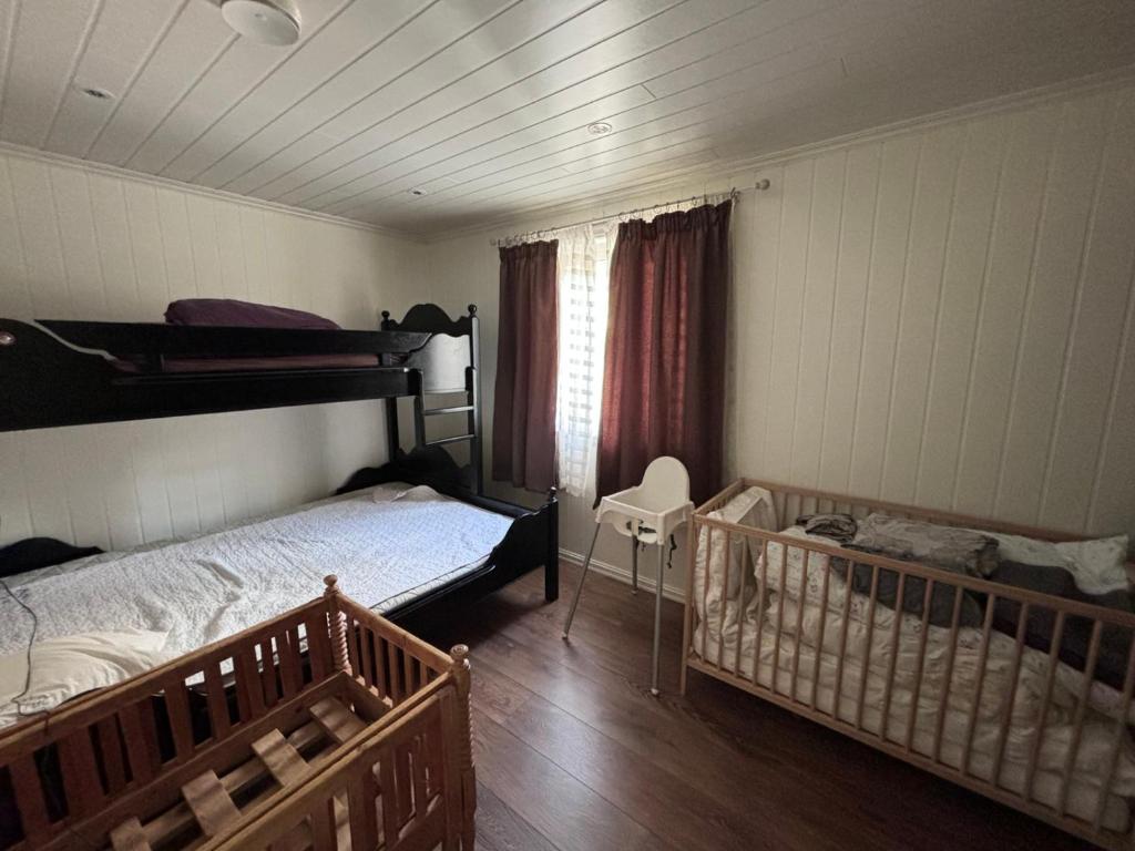 a bedroom with two bunk beds and a crib at Hytta in Bømlo