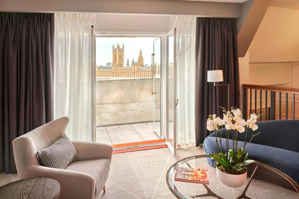 a living room with a couch and a glass table at London Marriott Hotel County Hall in London