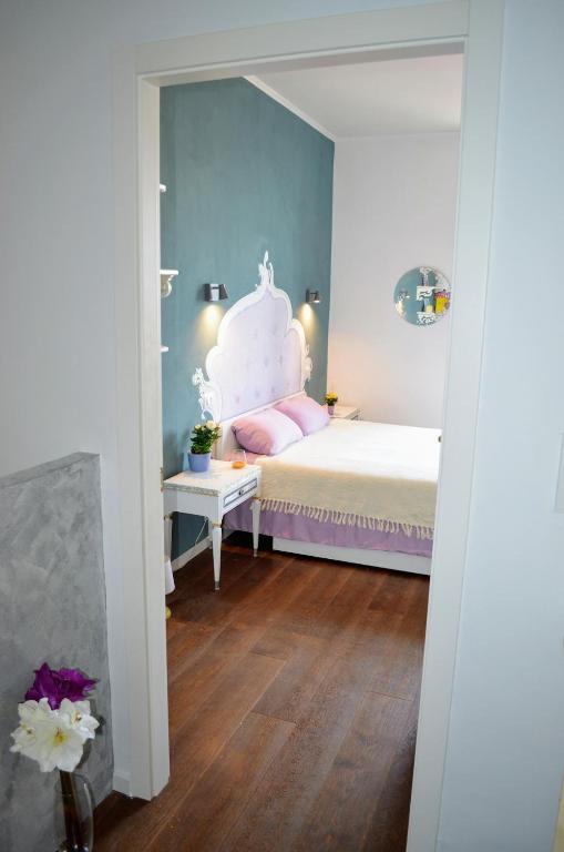 a bedroom with a bed with a white headboard at Lullaby Holiday in Trieste