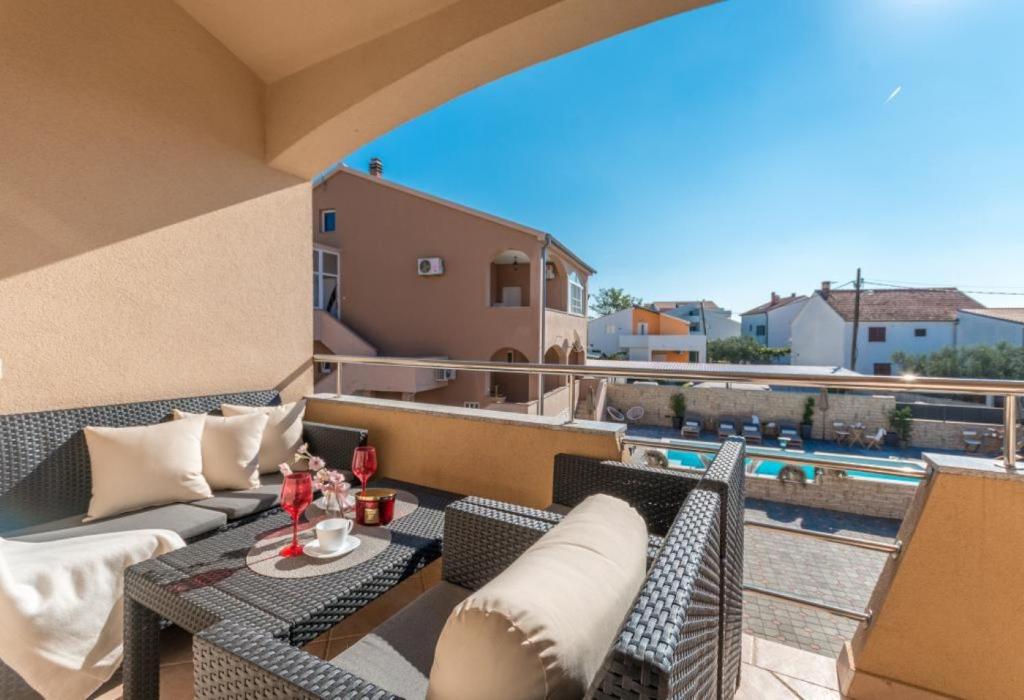 a balcony with a couch and a table on a patio at Apartment Julia A1 in Biograd na Moru