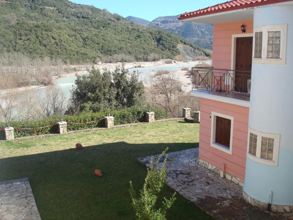 a house with a yard with a view of a river at Evinos Village Resort in Yéfira Baniá