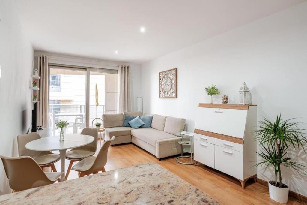 a living room with a couch and a table at FiveStepsToSea - Beach Apartment Valencia in Valencia