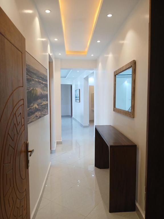 a hallway with a wooden door and a table at Beach Breeze 001 in Mombasa