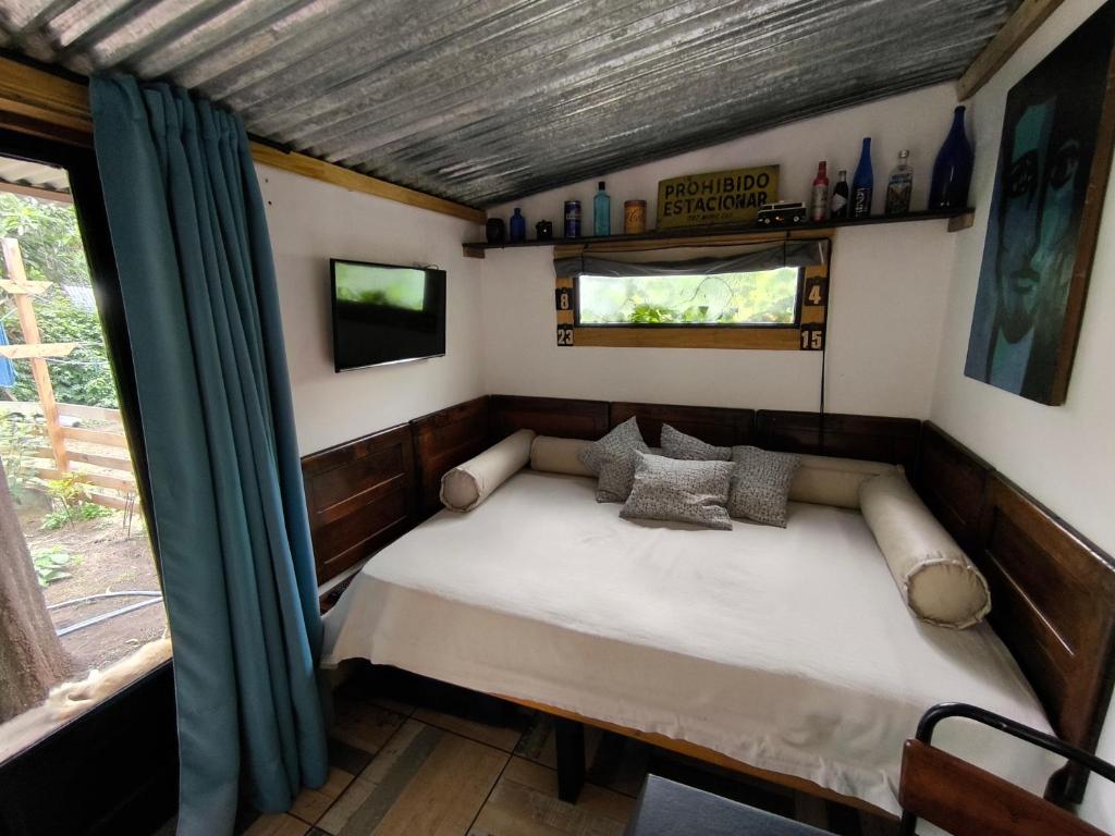 a small bed in a room with a window at El Tambucho Miramar BsAs in Miramar