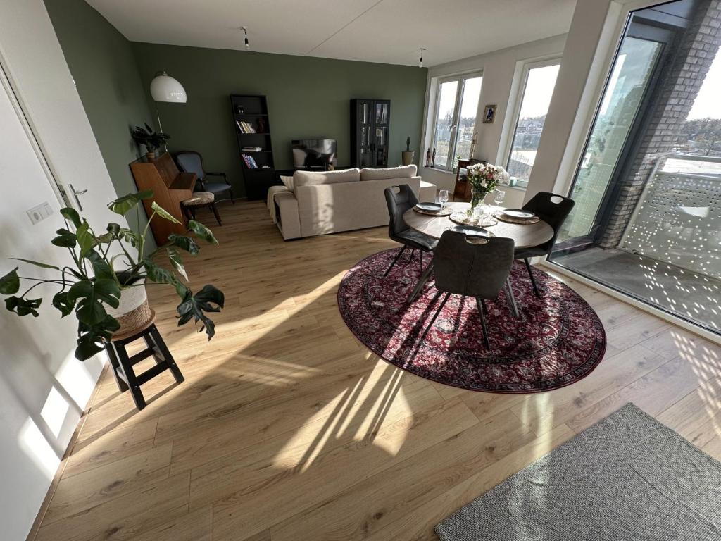 a living room with a couch and a table with a rug at Your perfect stay in Enschede! in Enschede