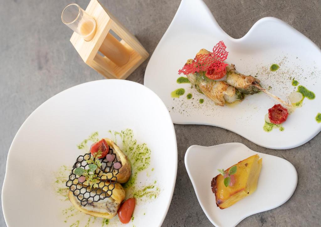 three white plates with different types of food on them at Fantinello Hotel in Caorle