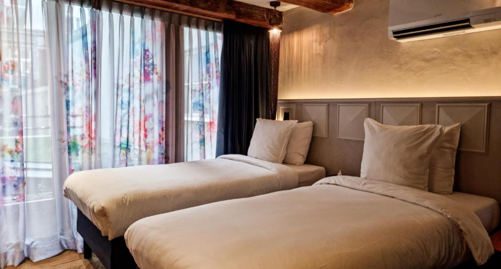 Postel nebo postele na pokoji v ubytování Mister Highland Hotel