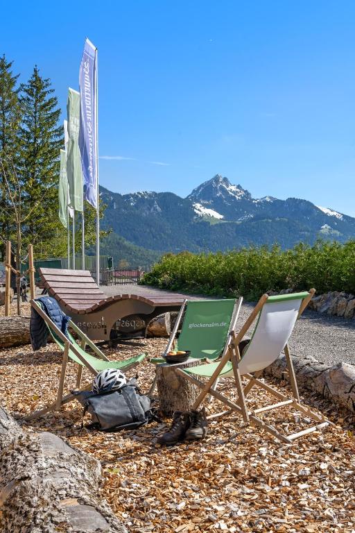two lawn chairs and a picnic table on a beach at Wendelstein Mountain Camp in Fischbachau