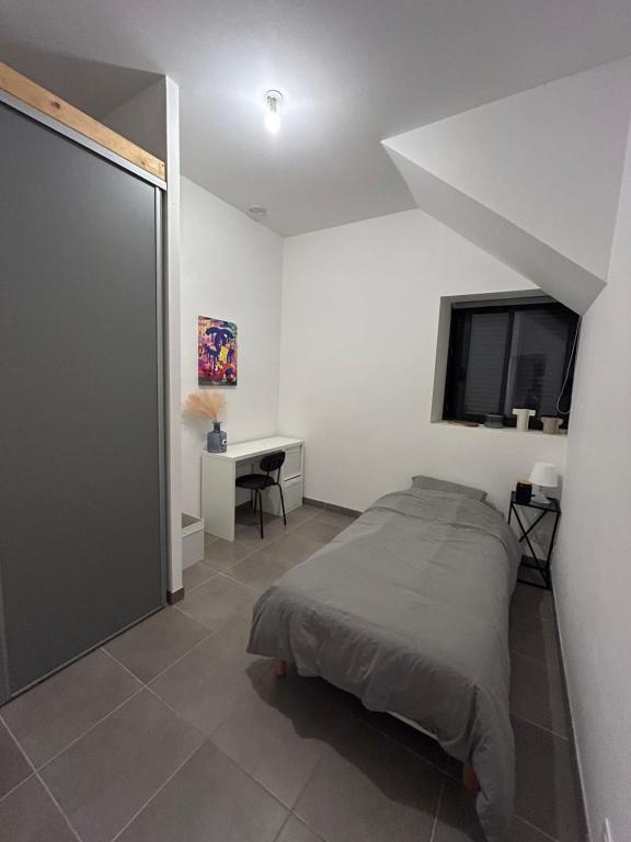 une chambre avec un lit et une télévision à écran plat dans l'établissement chambre meublée Nantaise dans un T3 commun avec terrasse, à Nantes