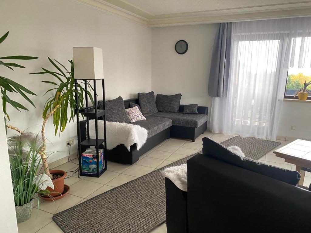 a living room with a bed and a couch at Ferienwohnung Frische Brise in Grafenhausen
