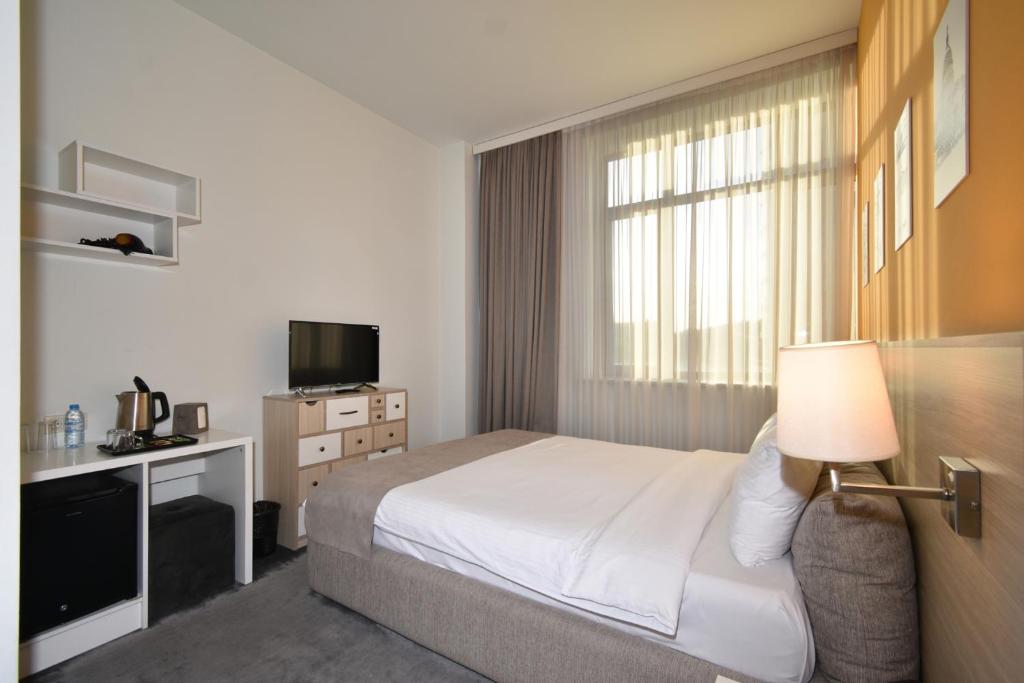 Postel nebo postele na pokoji v ubytování Hotel In City