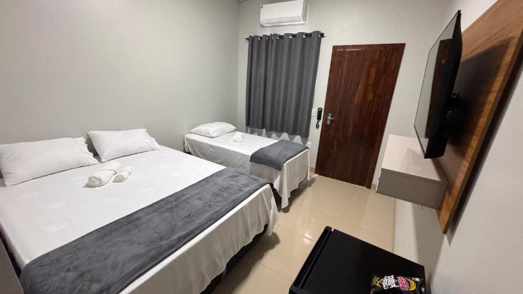 Ένα ή περισσότερα κρεβάτια σε δωμάτιο στο Hotel Pousada Prime